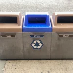 recycling and trash containers on sidewalk